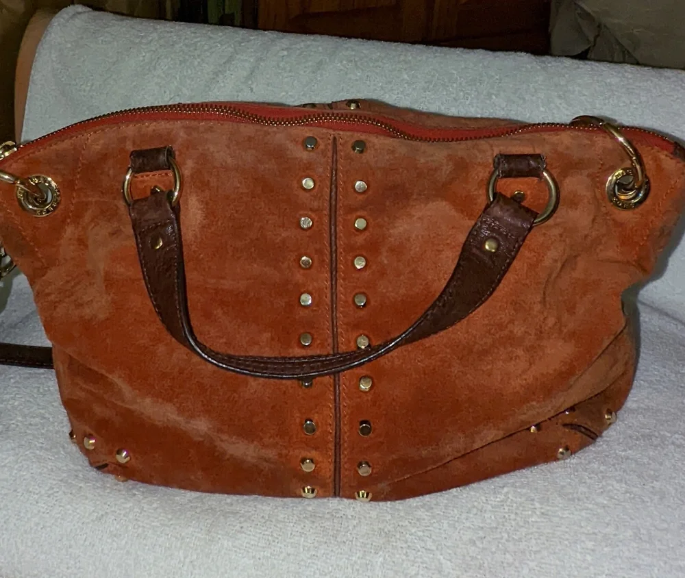Michael Kors orange suede studded slouchy shoulder bag.